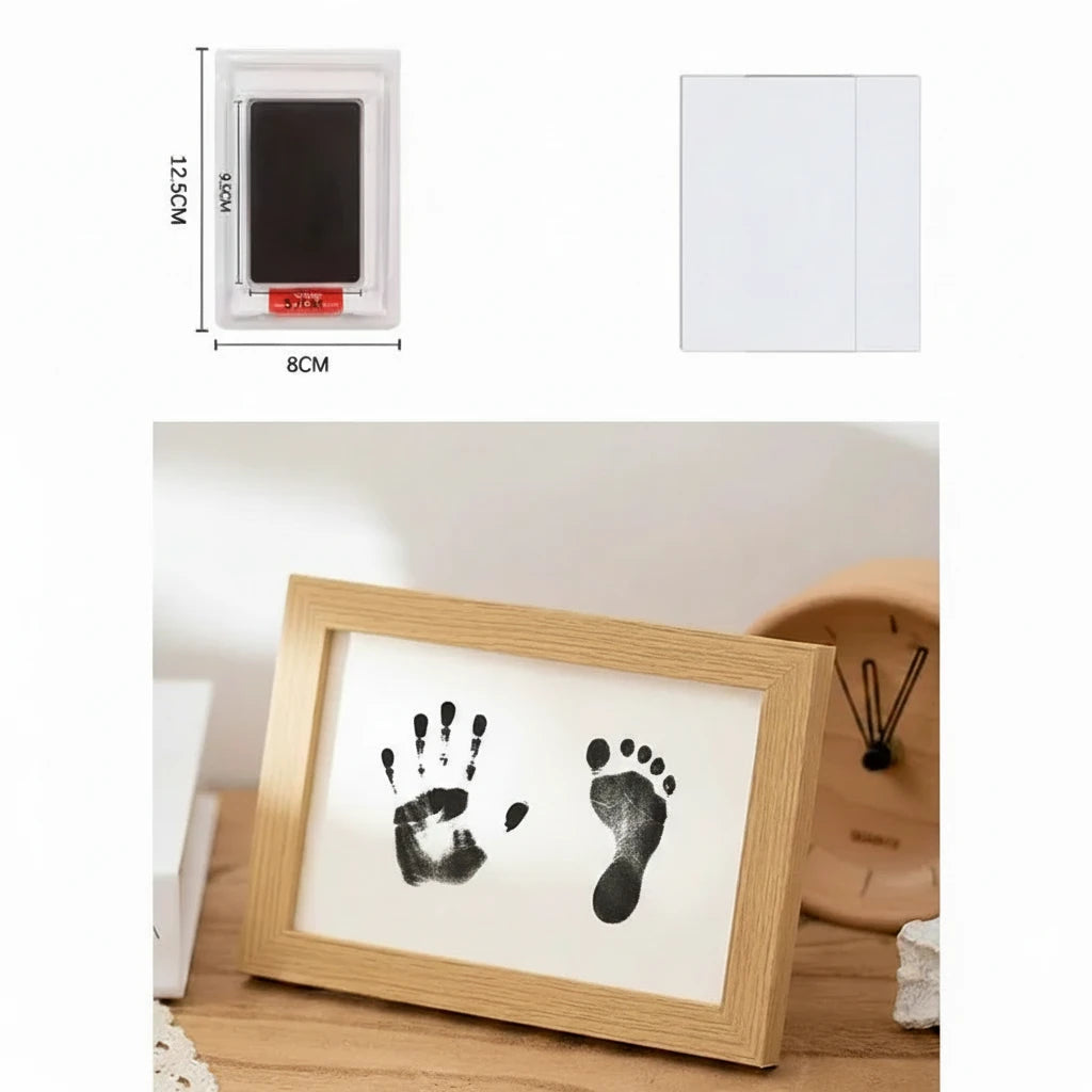 Framed black hand and foot prints on a white background with dimensions and a wooden frame.